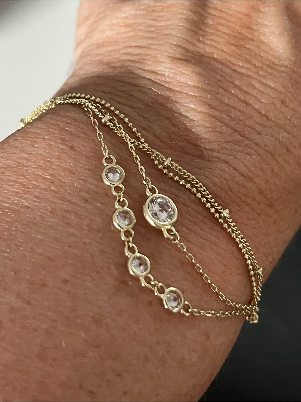 Stunning Kendra Scott multi strand gold tone bracelet with bezel set cz’s.